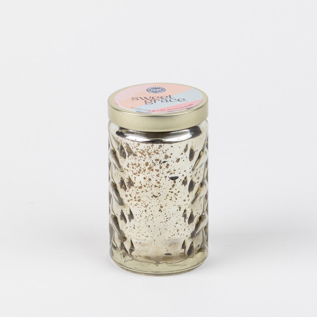 Sweet Grace Collection Candle #022 comes in a clear, textured glass jar with a gold lid.