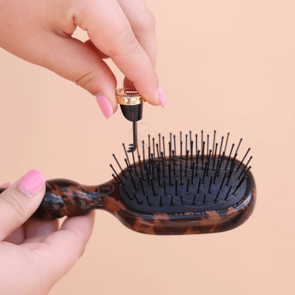 Mini Detangler Brush for Medium Hair | Tortoise shown being cleaned; available in mini size.