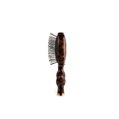 Mini Detangler Brush for Medium Hair in tortoiseshell with metal bristles and rounded handle; available in mini size.