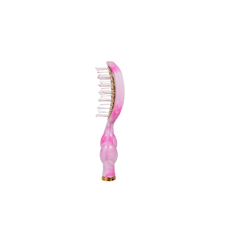 The Pinch Me! Tie Dye Pink Vented Hair Brush has wide-set bristles, a glossy pink and gold curved handle. Sizes available.