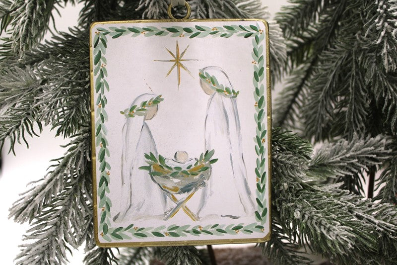 Double Sided Metal Glitter Holy Family Ornament ©Haley Bush with rectangular metal nativity scene, gold star, and green leaf border.