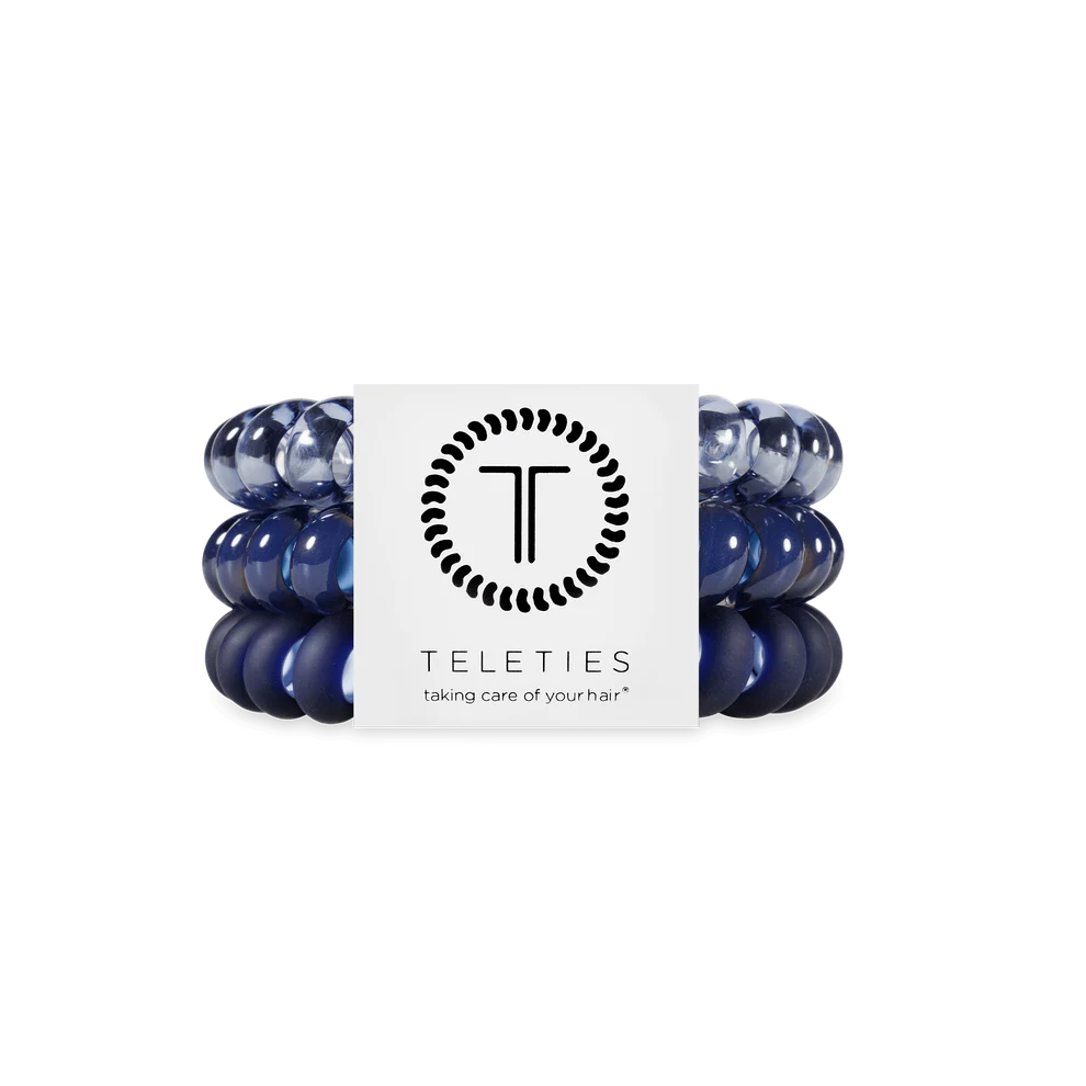 Three navy blue TELETIES hair ties on a branded card. Available in small, medium, and large sizes.