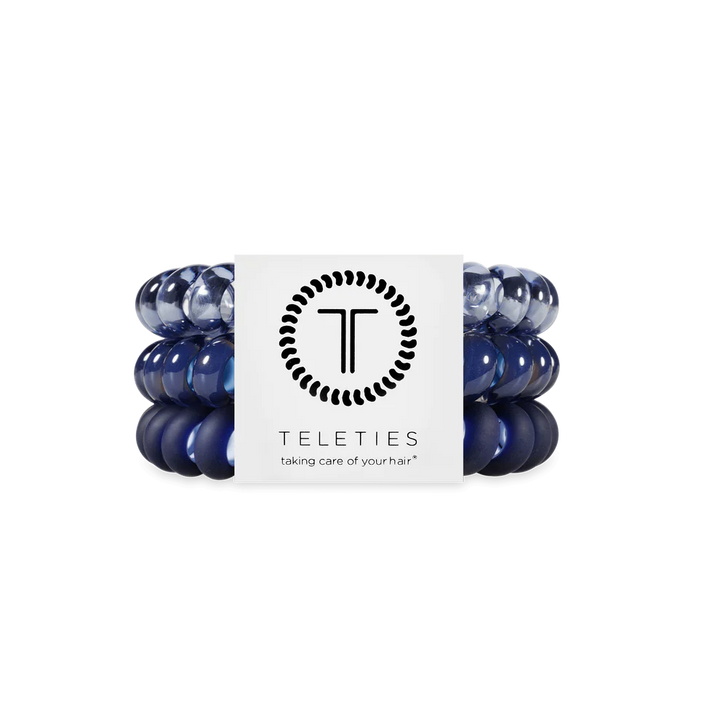 Three navy blue TELETIES hair ties on a branded card. Available in small, medium, and large sizes.