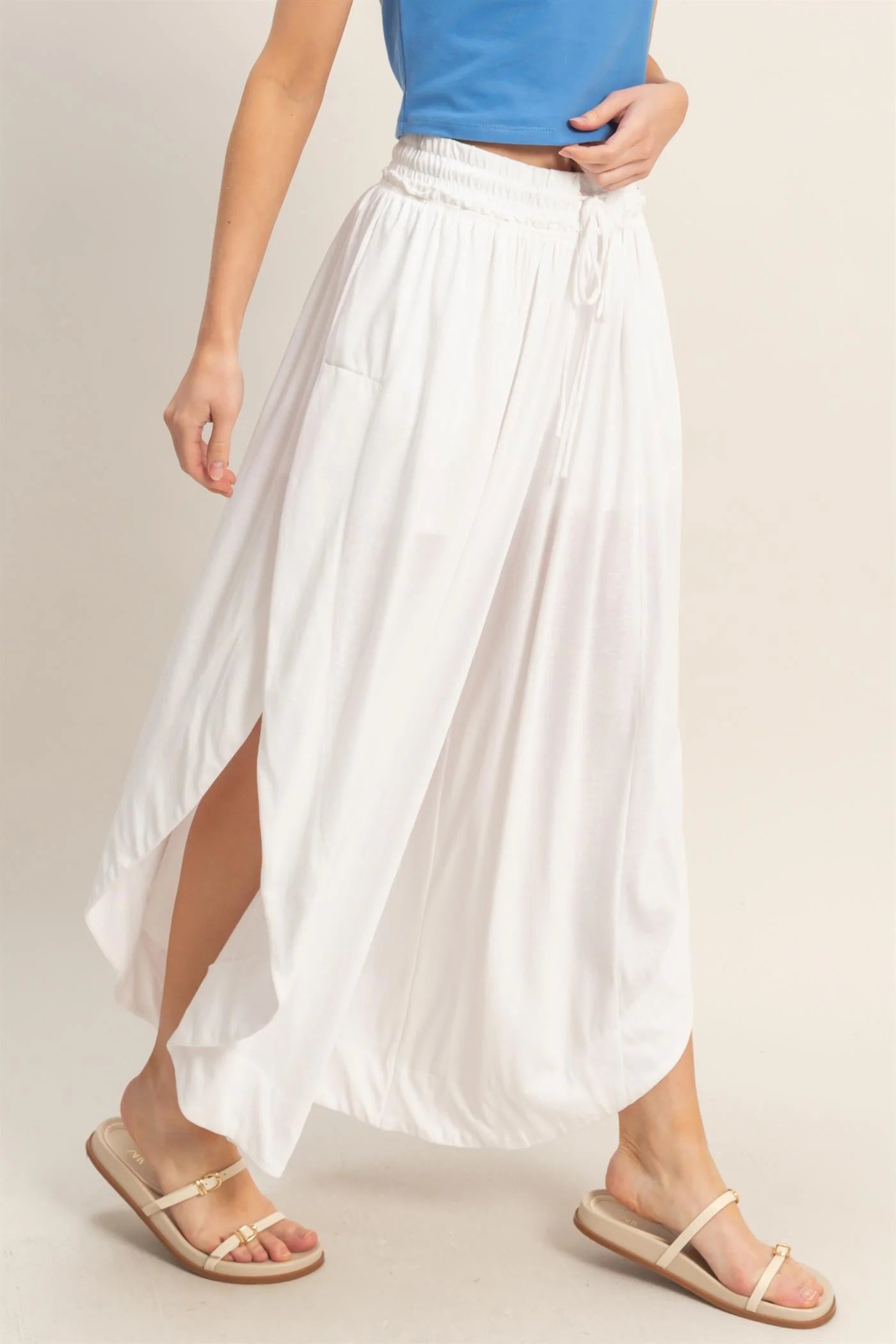 White Tulip Hem Wide-Leg Pants, available in sizes XS-XL.