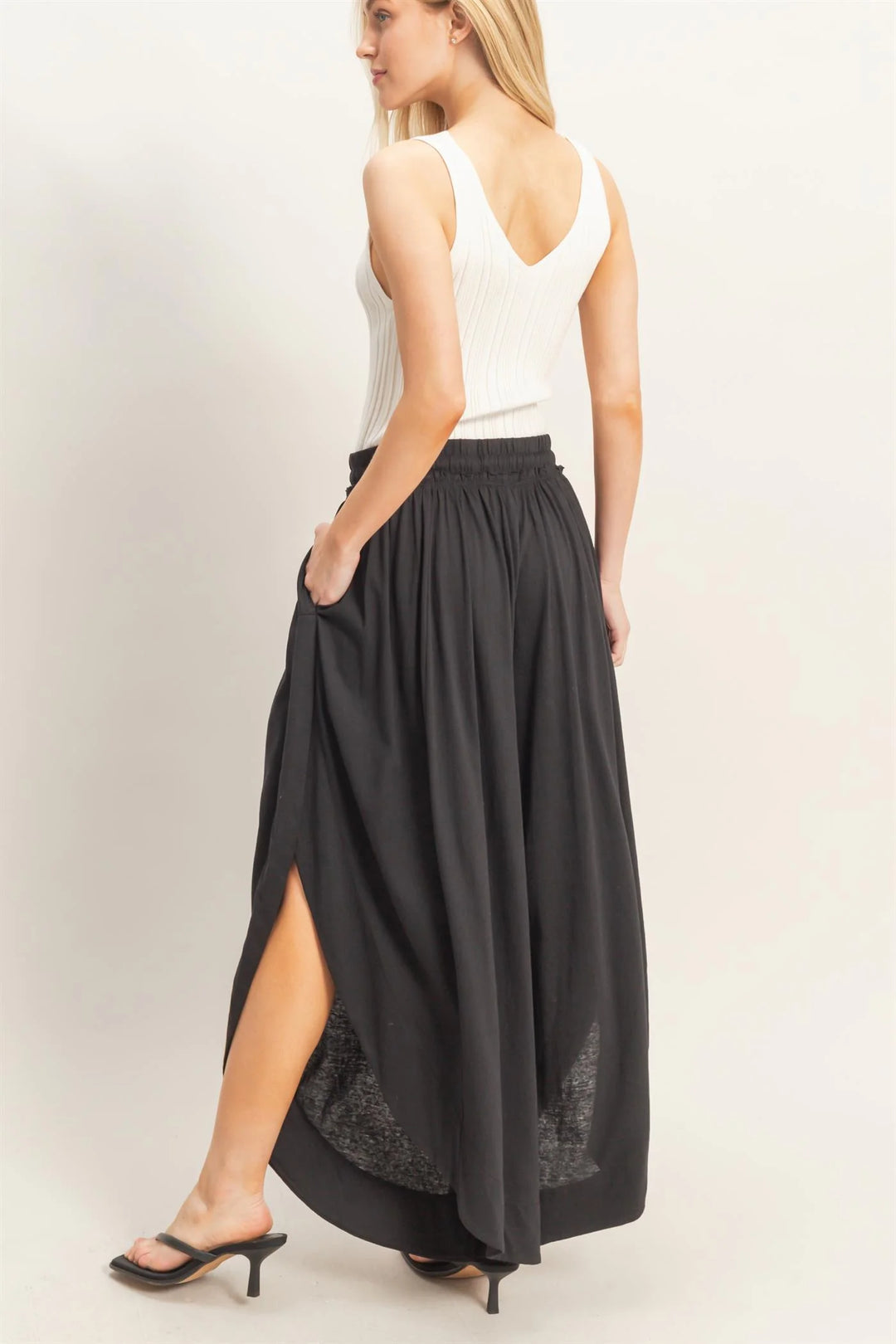 Black Tulip Hem Wide-Leg Pants, available in sizes XS-XL. Features tulip hem and wide-leg design.
