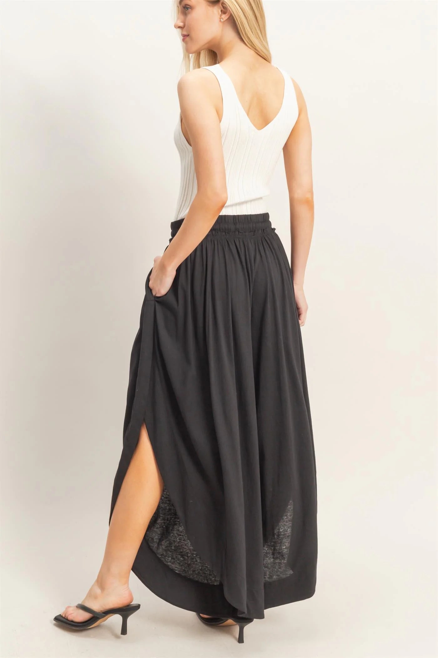 Black Tulip Hem Wide-Leg Pants, available in sizes XS-XL. Features tulip hem and wide-leg design.