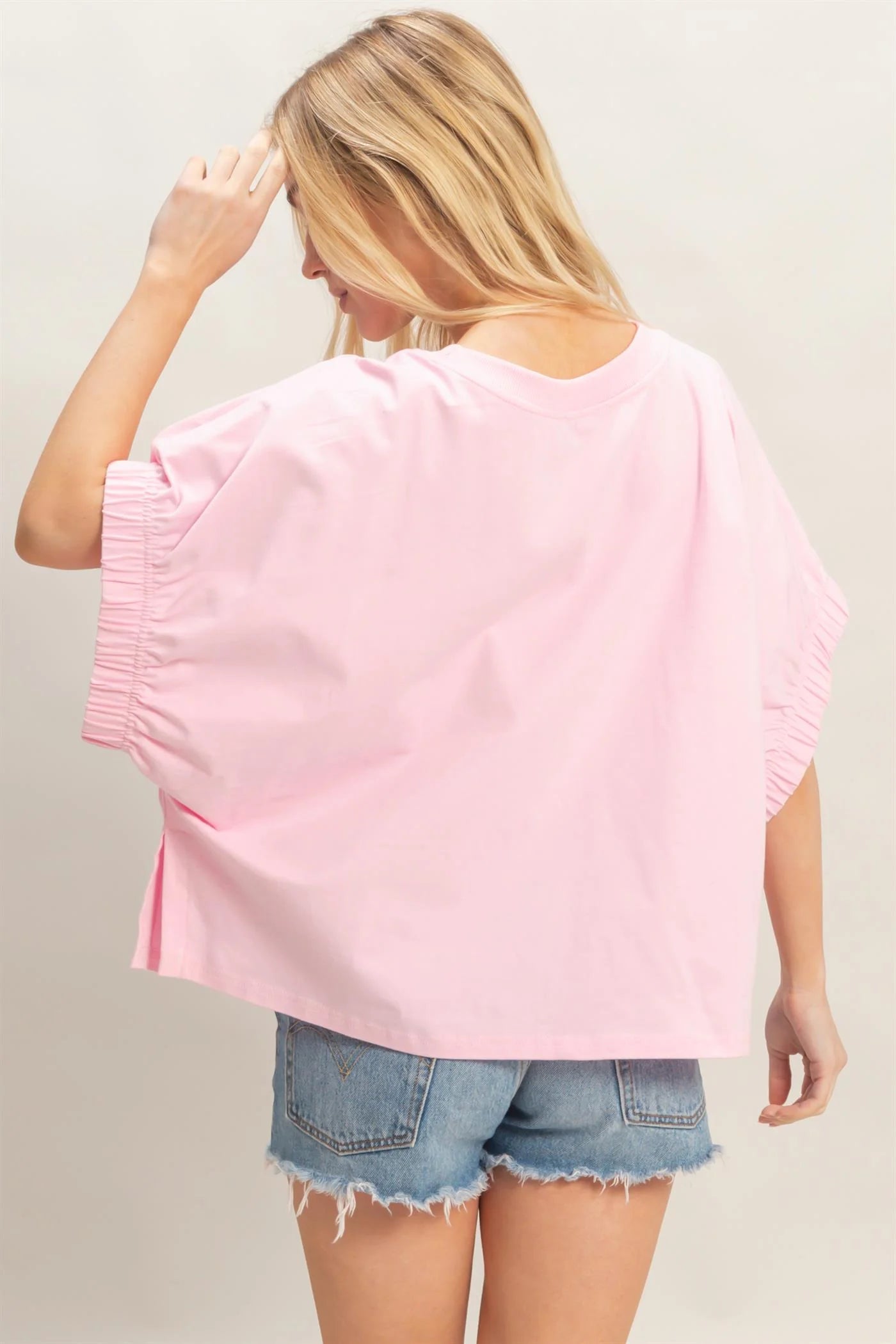 Light Pink Oversized Elastic Cuff Top with relaxed fit and gathered cuffs; available in sizes S-XL.