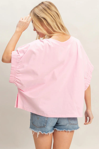 Light Pink Oversized Elastic Cuff Top with relaxed fit and gathered cuffs; available in sizes S-XL.