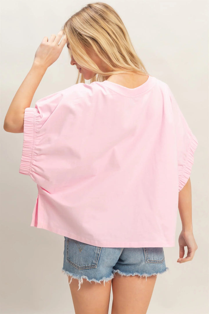 Light Pink Oversized Elastic Cuff Top with relaxed fit and gathered cuffs; available in sizes S-XL.