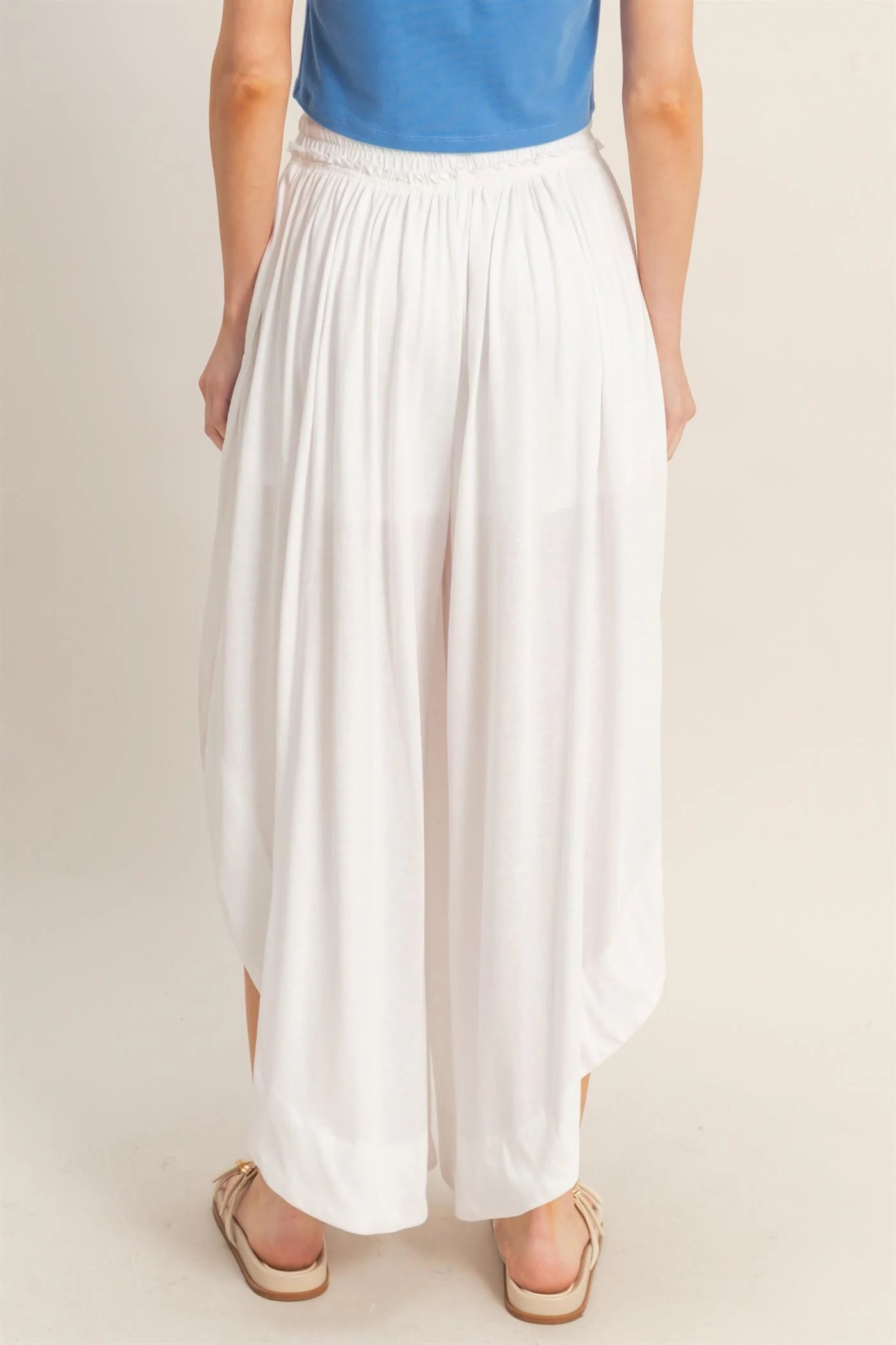 Tulip Hem Wide-Leg Pants with flowy silhouette and signature hem; available in sizes XS-XL.
