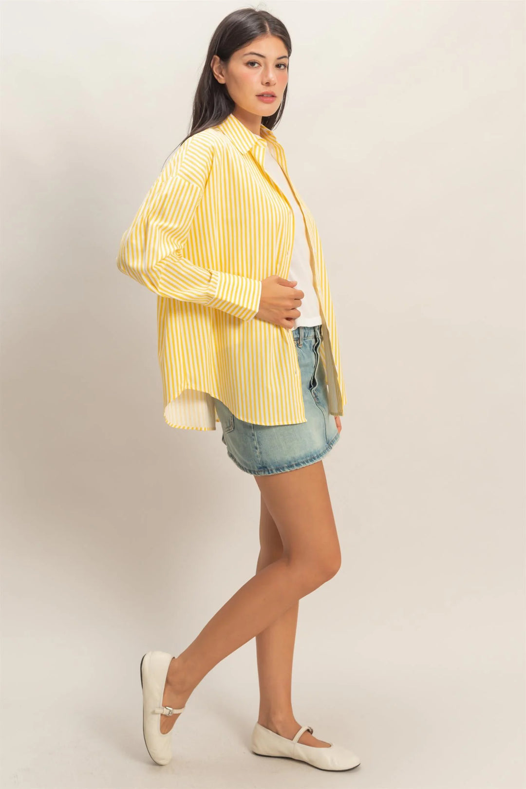 Oversized yellow and white striped button-up poplin shirt. Sizes: XS-XL.