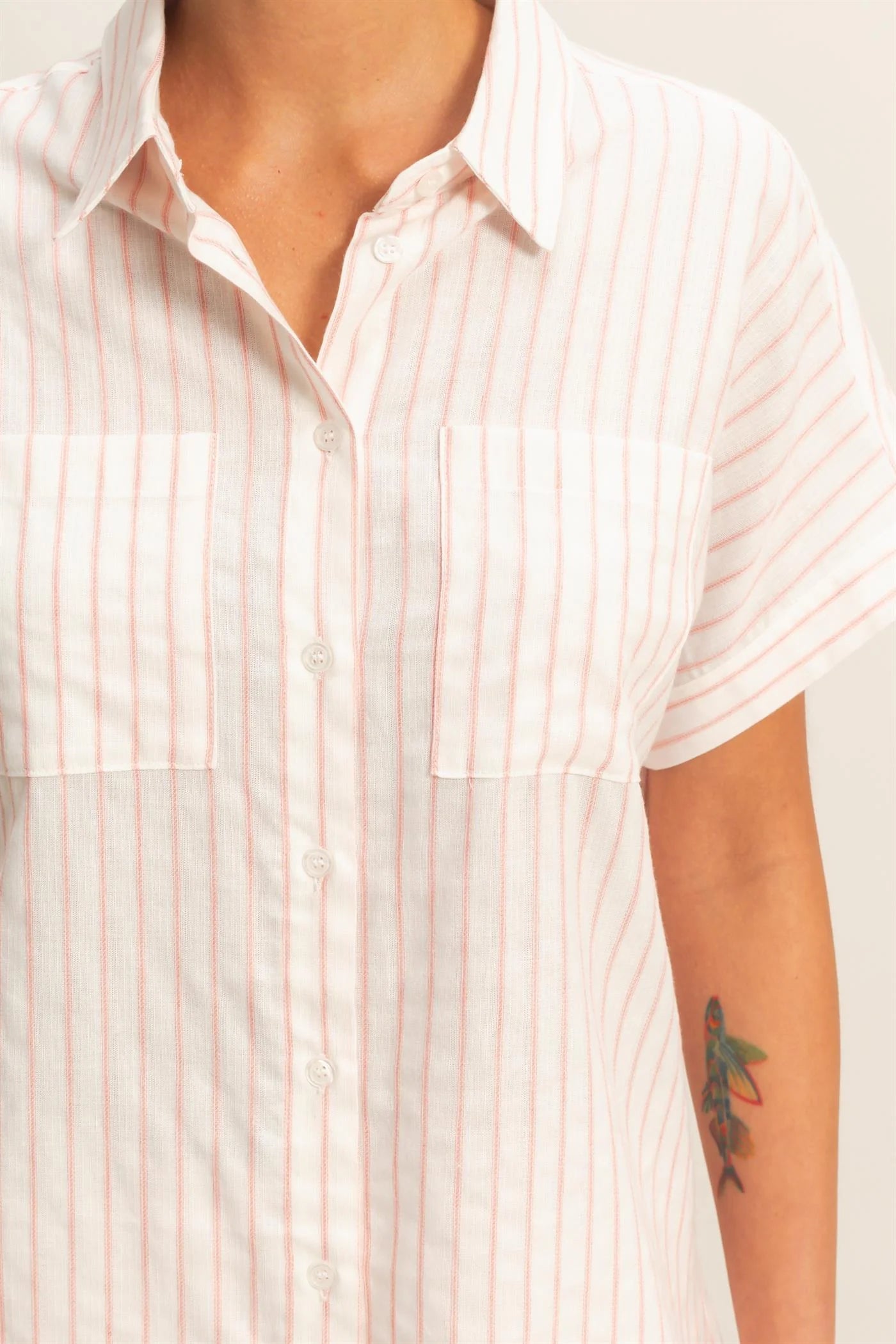 Striped Button-Up Dolman Sleeve Shirt in white with light pink stripes, two chest pockets, short sleeves. Sizes XS-XL.