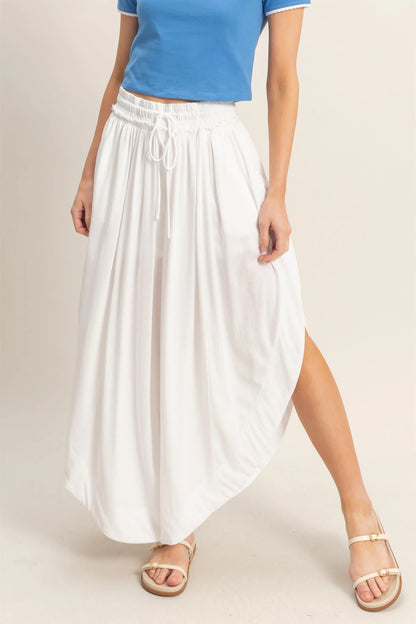 White Tulip Hem Wide-Leg Pants, flowy knit, drawstring waist, boho-chic style; available in sizes XS–XL.
