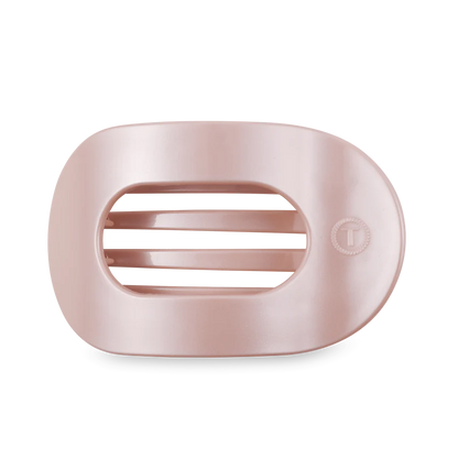 TELETIES' pink oval soap dish features three horizontal drainage slats and a round logo. It has a smooth, glossy surface for an elegant bathroom decor. Available in one size.