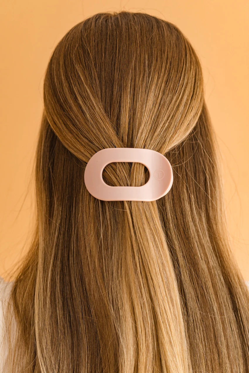 The TELETIES Flat Round Hair Clip is a large, innovative hair accessory available in pink, designed to secure long hair stylishly.
