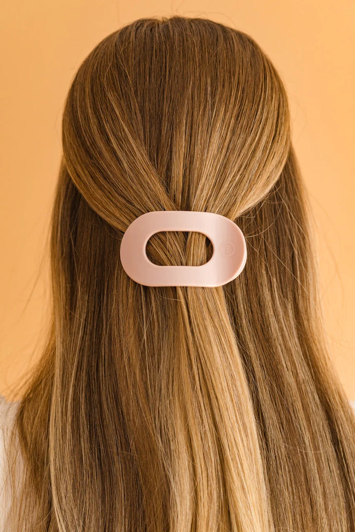 The TELETIES Flat Round Hair Clip is a large, innovative hair accessory available in pink, designed to secure long hair stylishly.