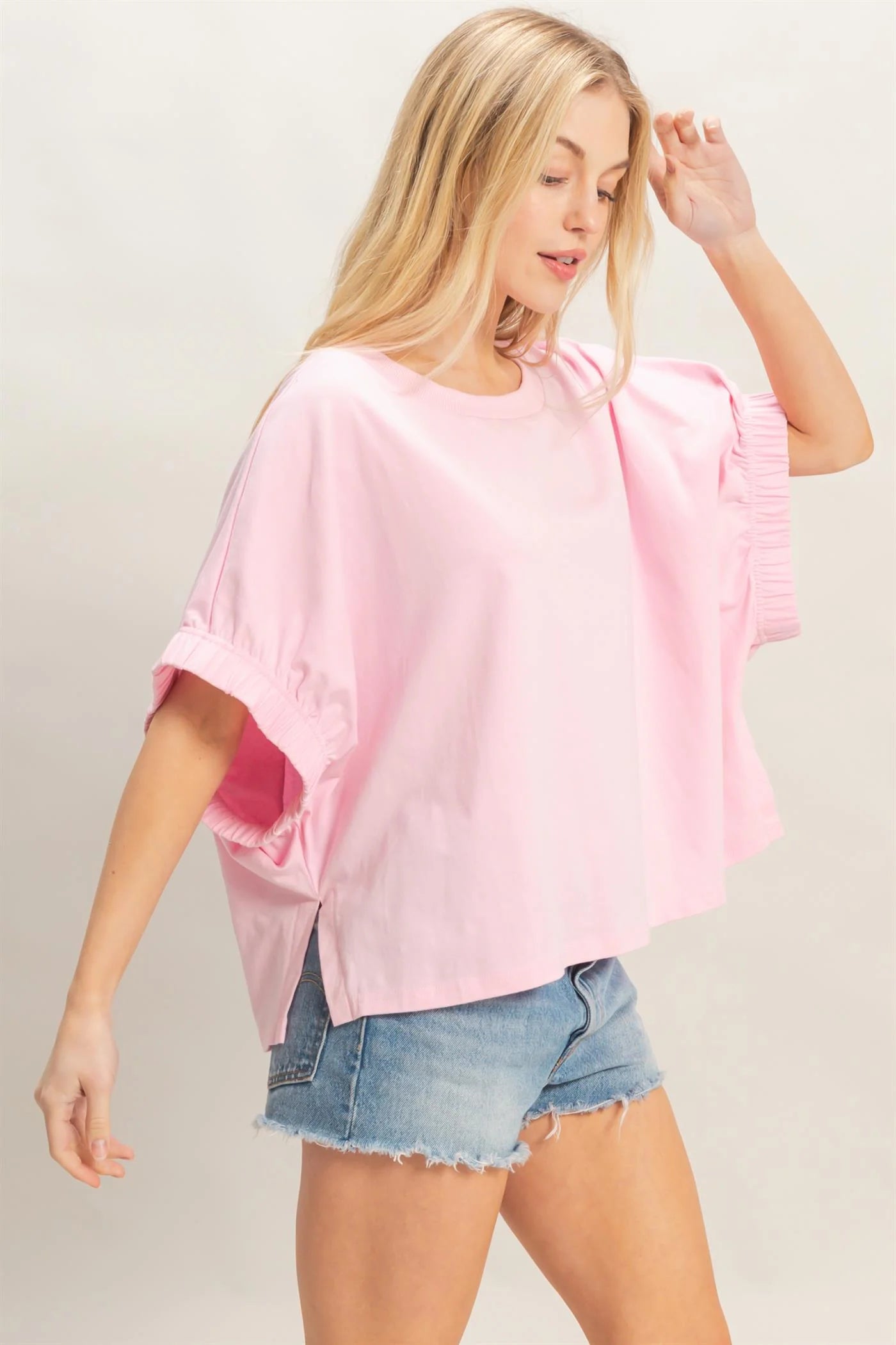 Light Pink Oversized Elastic Cuff Top with relaxed fit and cuffed sleeves. Available in sizes XS-XL.