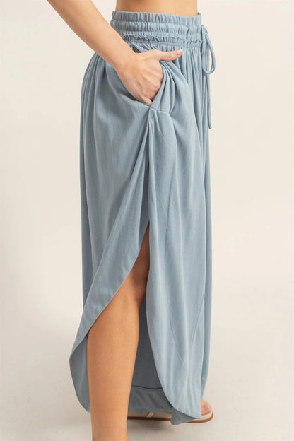 Light blue Tulip Hem Wide-Leg Pants with high slit, elastic waistband, drawstring, side pockets. Sizes: S-XL. 3 colors.