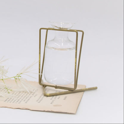 The 3.5" Metal Stand with Glass Vase in gold offers an elegant display, perfect for holding water and enhancing floral arrangements. Available size: 3.5 inches.