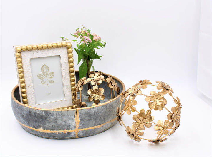 White and gold wood beaded photo frame, 8.5", fits 4"x6" photos, features a leaf print.