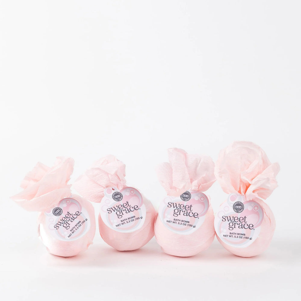 Set of four Sweet Grace Bath Bombs with white tags and pink accents, wrapped in tissue. Available in 4.5 oz size each.