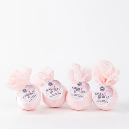 Set of four Sweet Grace Bath Bombs with white tags and pink accents, wrapped in tissue. Available in 4.5 oz size each.