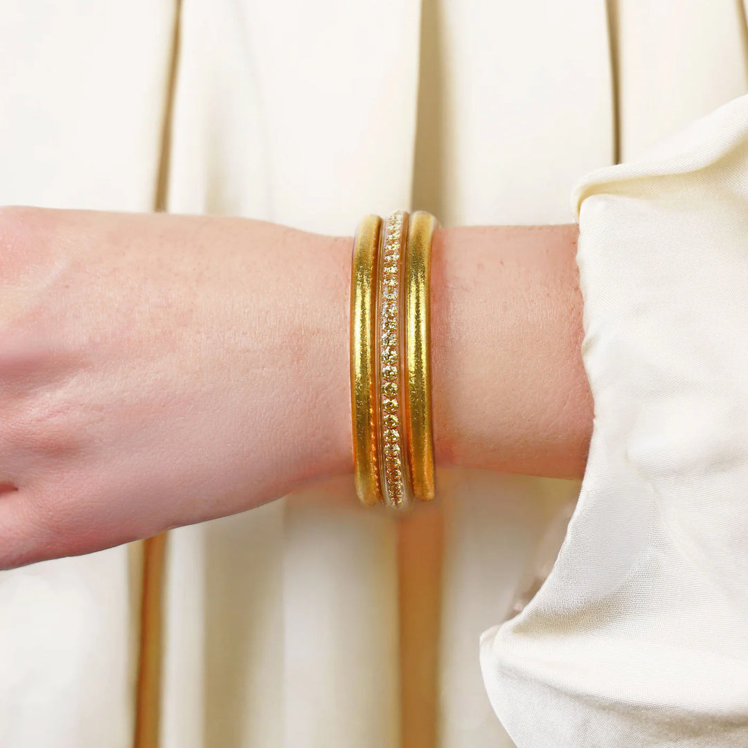 The Gold Queen Stack: two gold bangles, one with clear gemstones. Available in S, M, L.