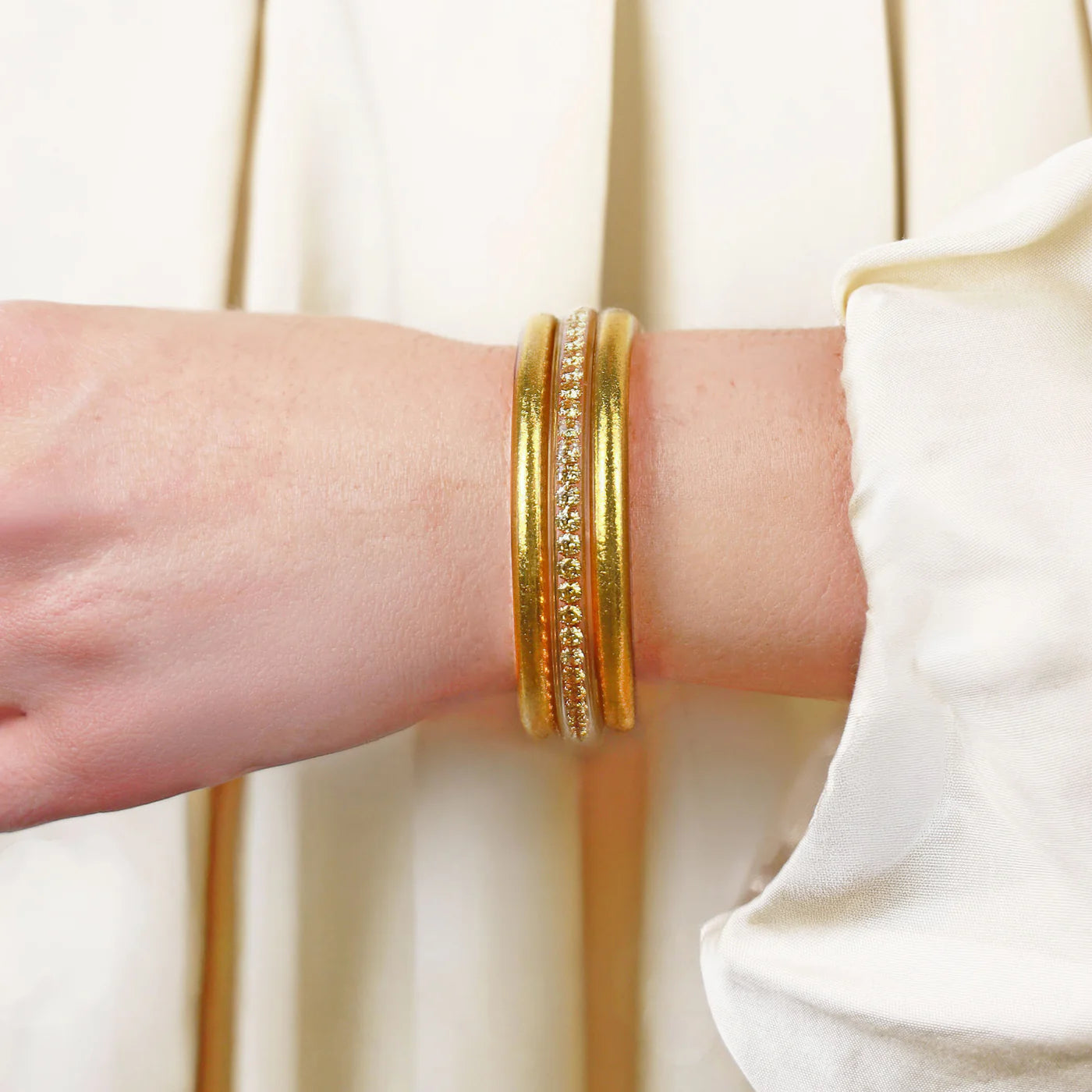 The Gold Queen Stack: two gold bangles, one with clear gemstones. Available in S, M, L.