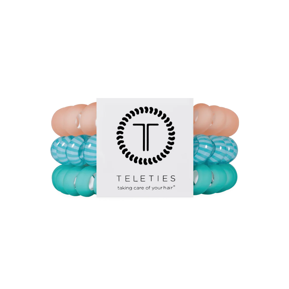 Three TELETIES Hair Ties—two teal/white striped, one solid peach. Available in small, medium, and large sizes.