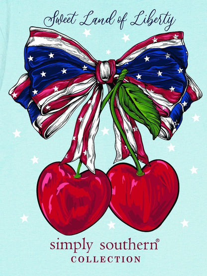Sweet Land of Liberty Cherry Bow T-Shirt with stars and stripes bow, red cherries, green stem; available in sizes S-XL.