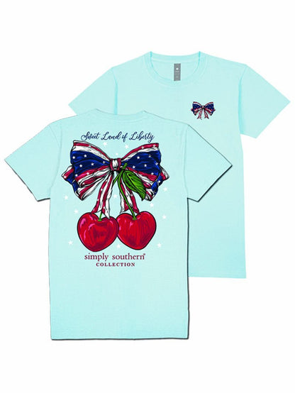 Light blue tee with small American flag bow on front, large patriotic cherry bow and “Sweet Land of Liberty” on back. Sizes S-XXL.