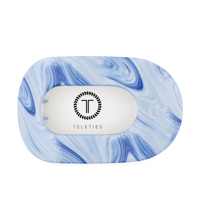 Flat Round Hair Clip in blue and white tie-dye, rectangular shape, TELETIES logo on white center. Available in multiple sizes.