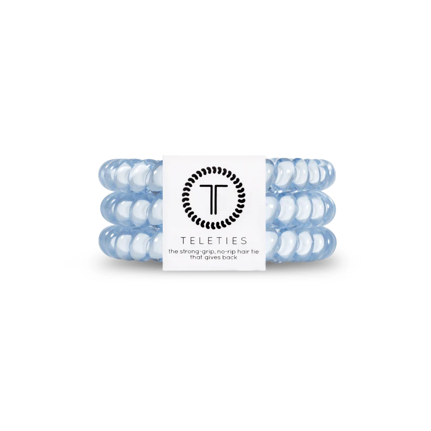 A chic set of light blue TELETIES coiled hair ties with a central white logo band, known for their strong grip and no-rip feature. Available in small and large sizes.