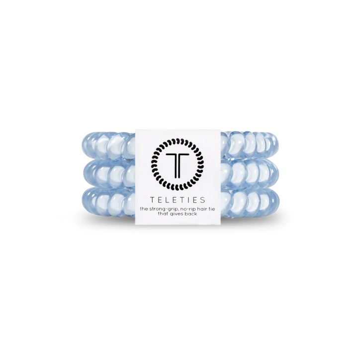 A chic set of light blue TELETIES coiled hair ties with a central white logo band, known for their strong grip and no-rip feature. Available in small and large sizes.
