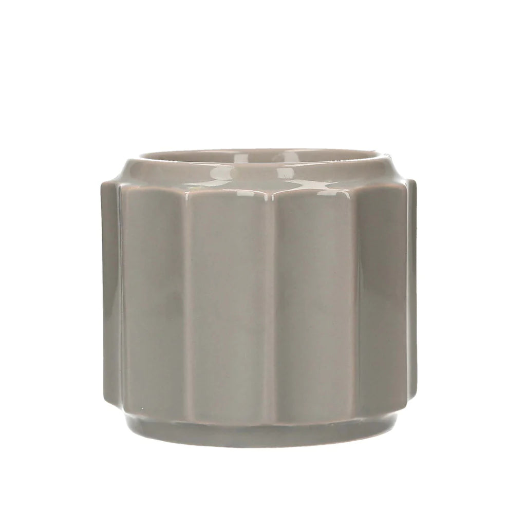 Glossy light gray wax warmer with fluted geometric design, cylindrical shape. Available in multiple sizes.