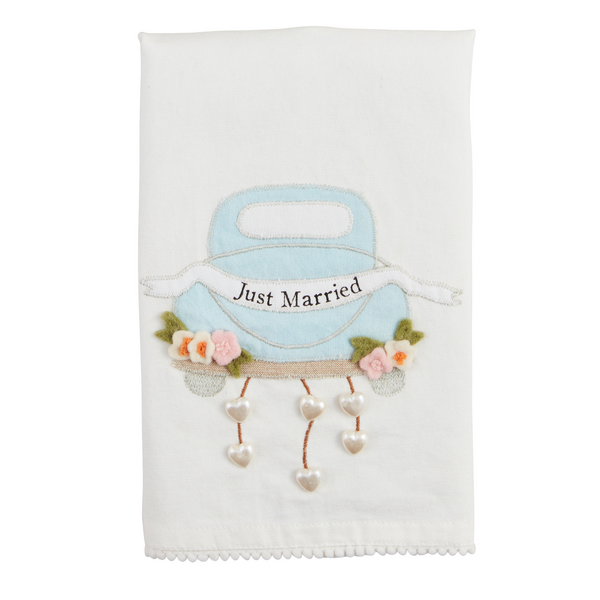 The Wedding Beaded Tea Towel is a white cotton hand towel featuring a premium appliqué of a blue car with "Just Married," adorned with flowers and heart charms. Available in standard size.