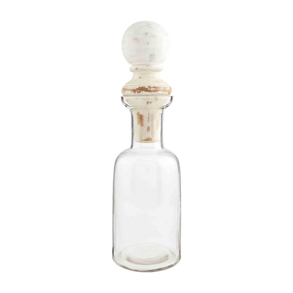 Clear glass decanter with wide neck, cylindrical body, and distressed white mango wood stopper. Sizes: 30oz, 48oz.