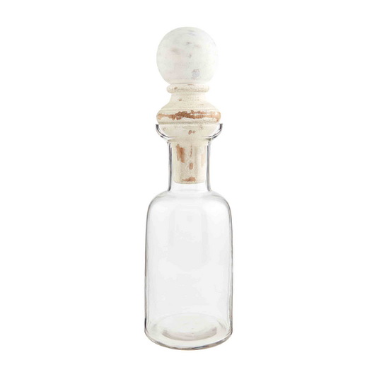 Clear glass decanter with wide neck, cylindrical body, and distressed white mango wood stopper. Sizes: 30oz, 48oz.
