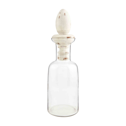 Clear glass decanter with wide neck and egg-shaped light mango wood stopper. Available in small and large sizes.