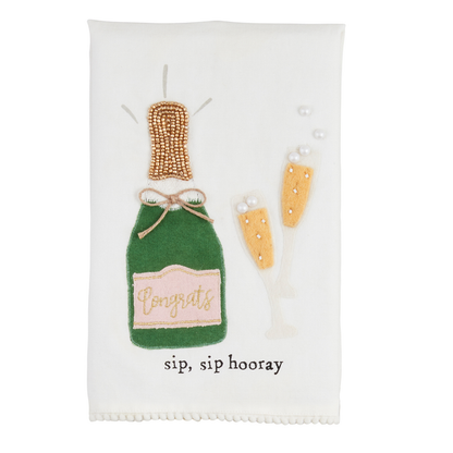 The Wedding Beaded Tea Towel is a premium cotton hand towel featuring an embroidered green champagne bottle labeled "Congrats," with two filled glasses, decorative trim, and the phrase "sip, sip hooray." Sizes available: One size.