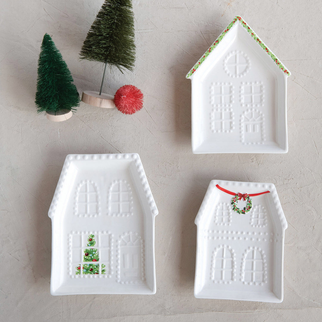 Three white Embossed Stoneware House Plates in 3 styles with embossed and painted festive holiday details.