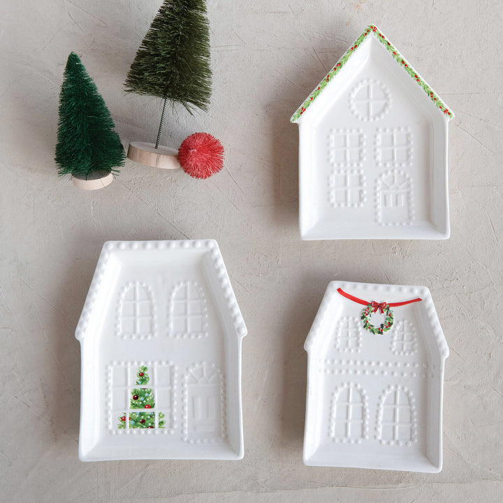 Three white Embossed Stoneware House Plates in 3 styles with embossed and painted festive holiday details.