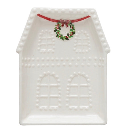 White embossed stoneware house plate featuring windows, a decorative wreath, and a red bow. Available in multiple sizes.