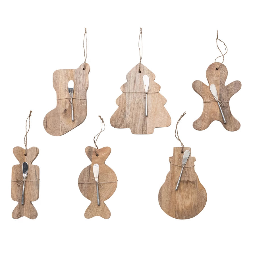 Set of 2 mango wood boards with canapé knives in 6 festive shapes: stocking, tree, gingerbread man, candy, and snowman, tied with jute.