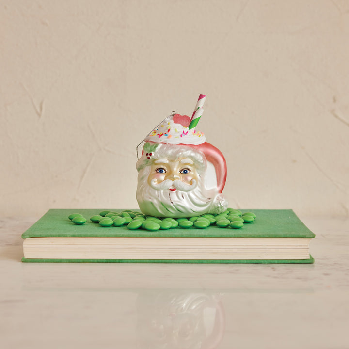 Glass Santa Head Mug Ornament with whipped cream, sprinkles, and a striped straw. Available in various sizes.