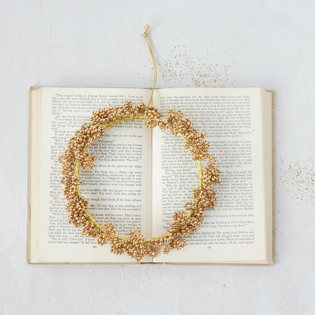 Gold handmade metal beaded wreath ornament.