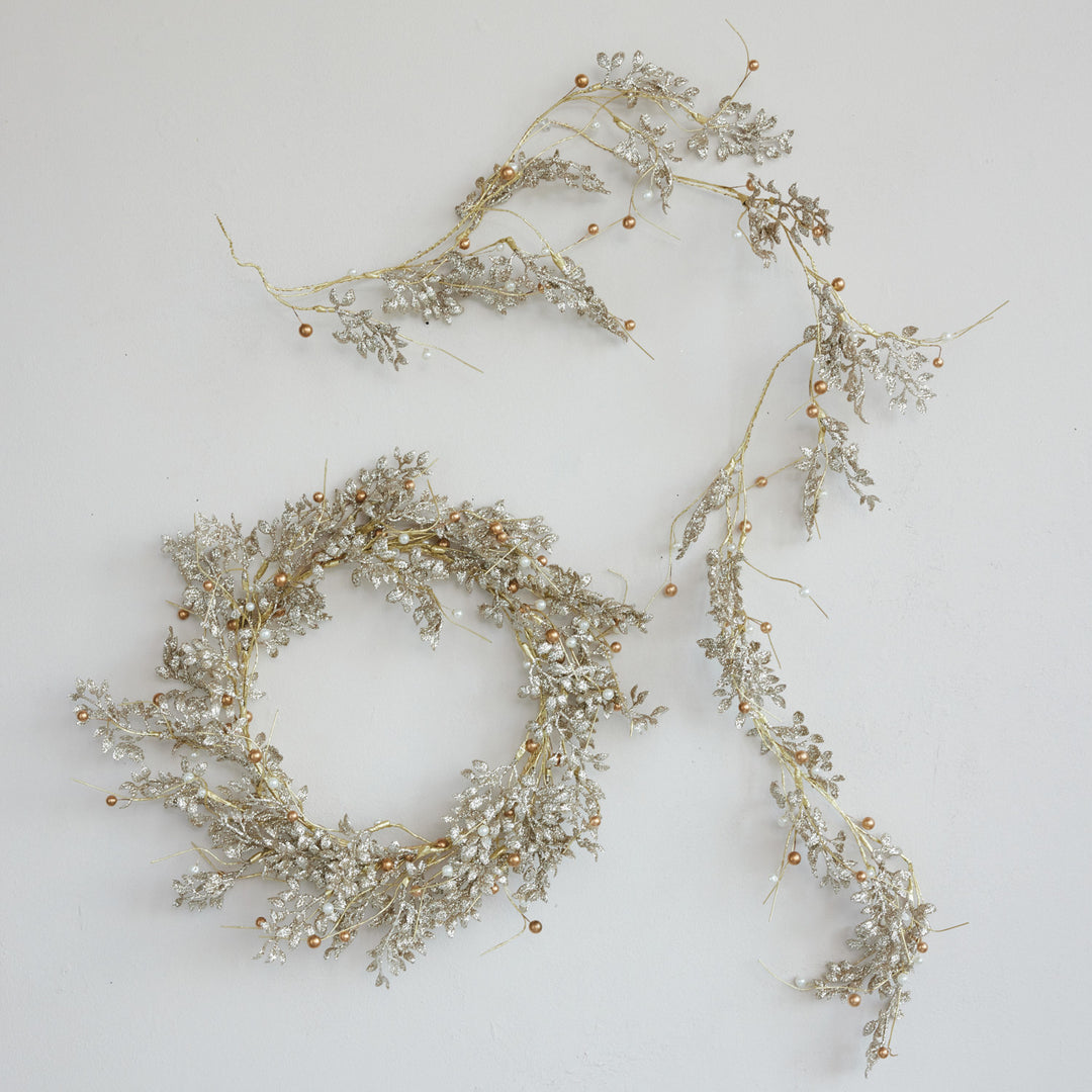 Gold and silver pearl bead garland featuring a decorative wreath and metallic leaf and bead strands.