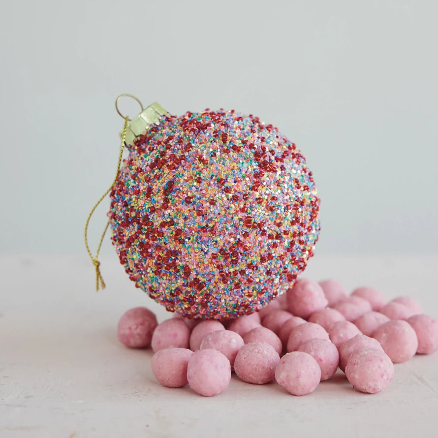3″ round, handcrafted, multicolored beaded and glittered glass ball ornament with a gold hanging loop.