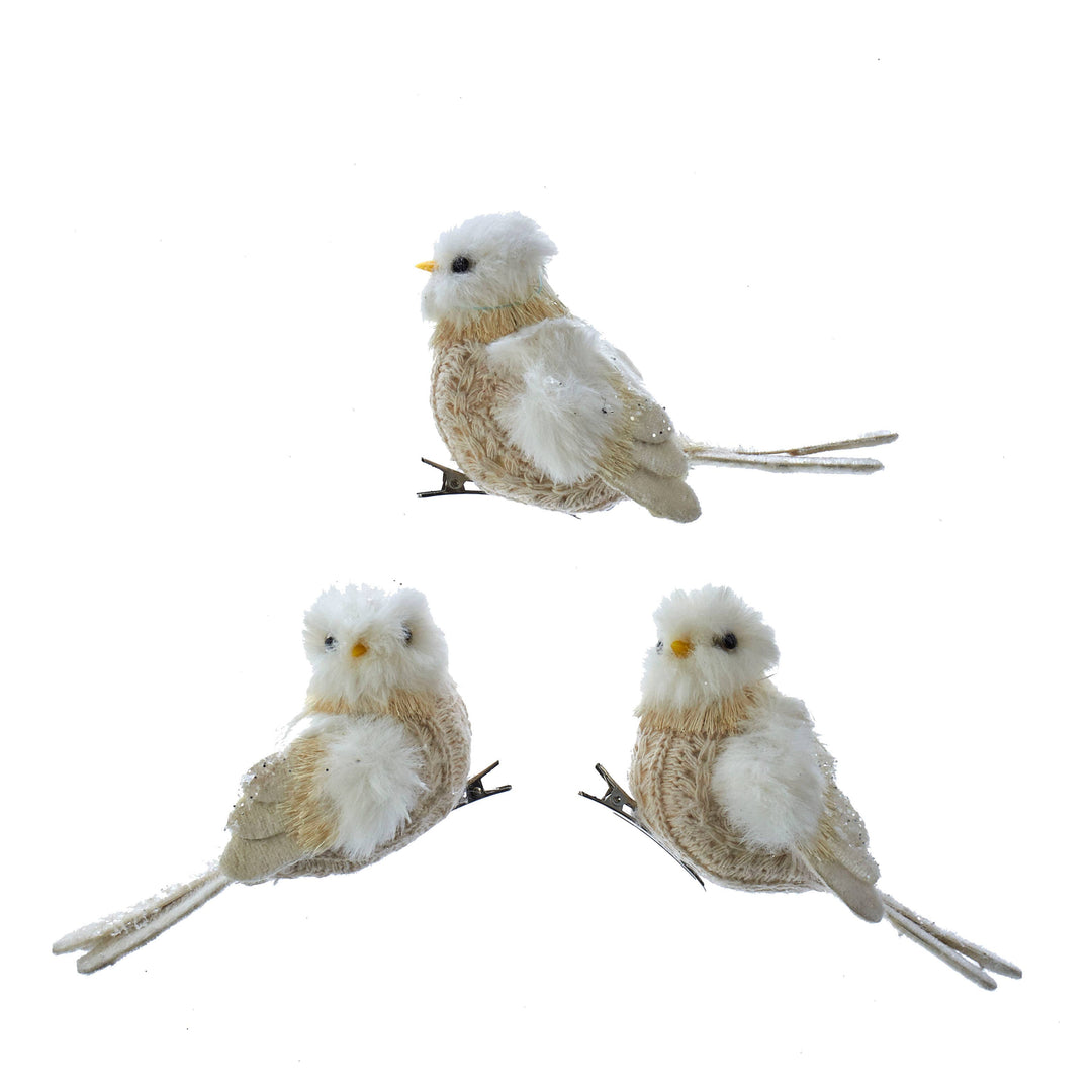 Three beige fur bird ornaments with white accents and metal clips.
