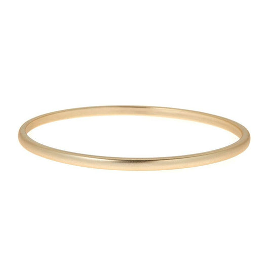 Brush Gold Peyton Bangle: simple, thin, polished finish. Sold individually. Available in S/M and M/L sizes.